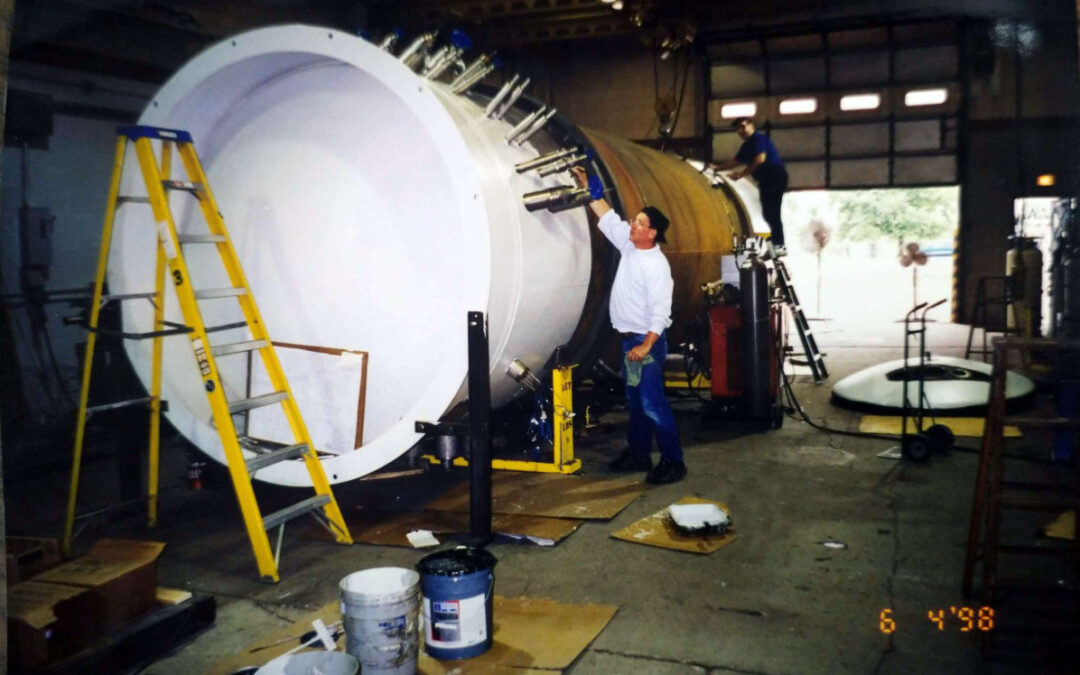 This is an image of manufacturing a cold box purification system. Painting Exterior of Vacuum Vessel in Image